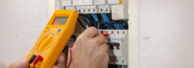 Electrician carrying out checks on a fuse box