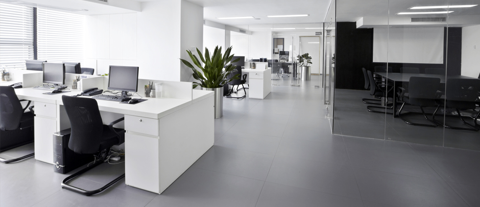 Clean, modern office with white desks and black chairs