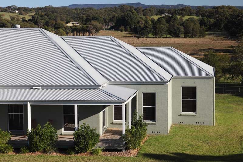 side view of a white house with white roof