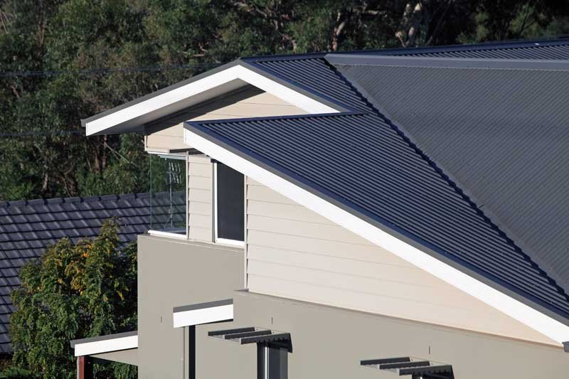 a tan house with a dark gray roof