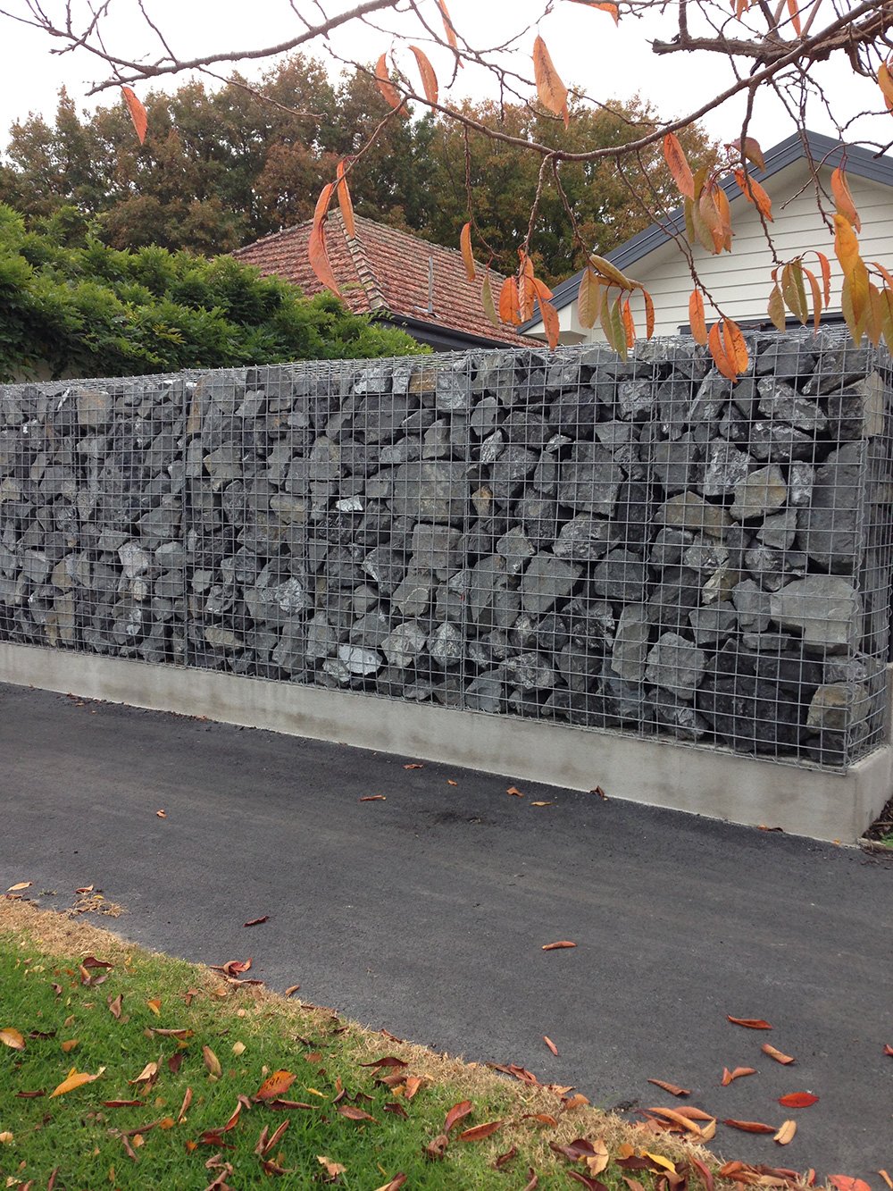 View of a mesh fence around the stone wall