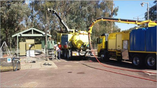 large yellow sewage trucks