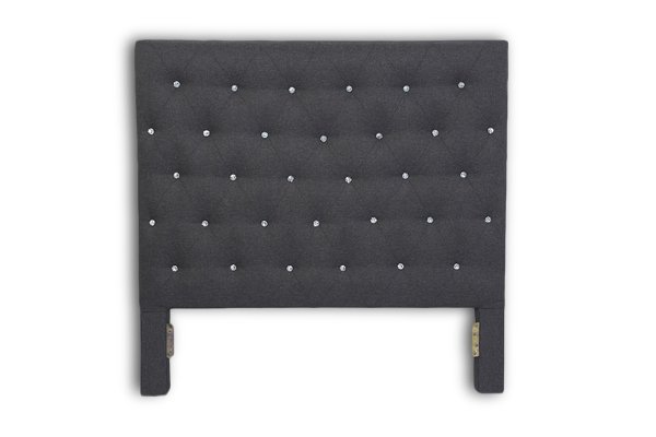 Cabecero capitoné de color gris oscuro con botones efecto cristal.