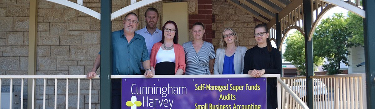 Cunningham and Harvey staff with board