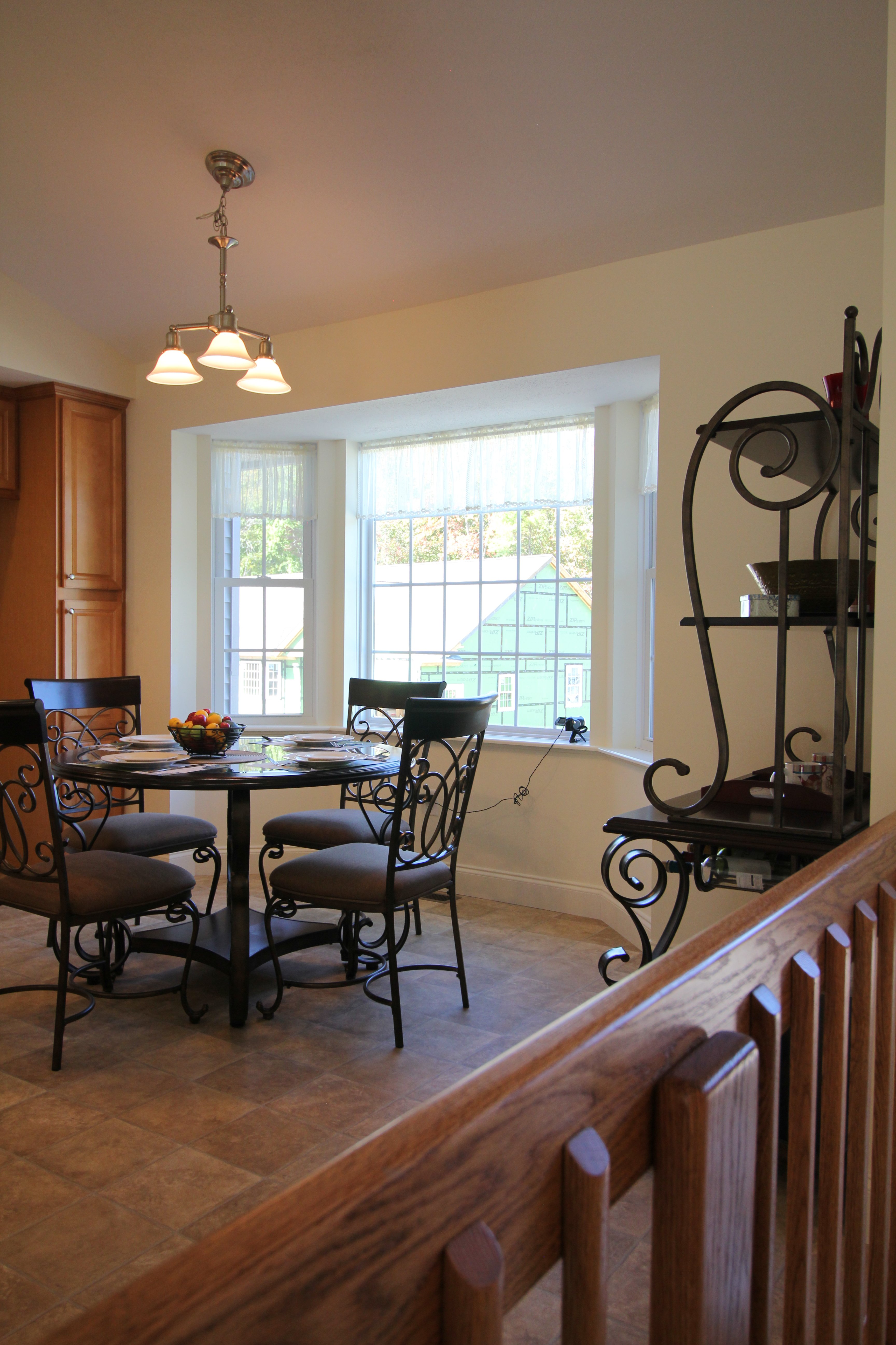 A dining room with a table and chairs and a window
