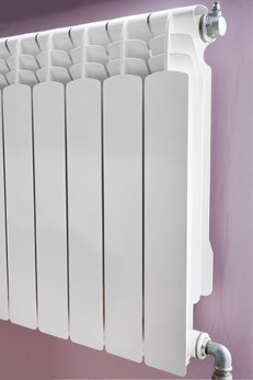 White radiator attached to a wall in a house