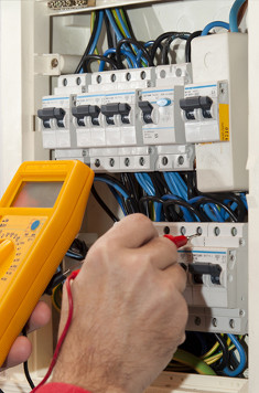 Electrician working on fuseboard