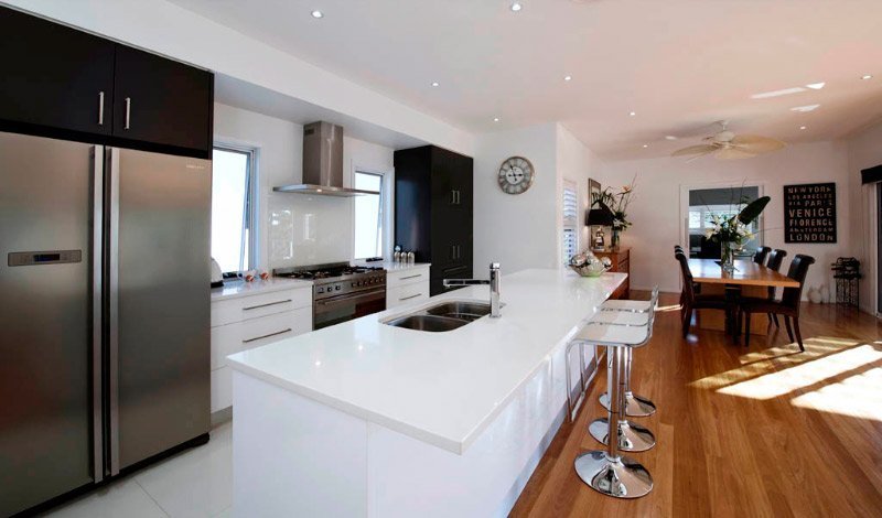 white kitchen island and bar with white counter tops