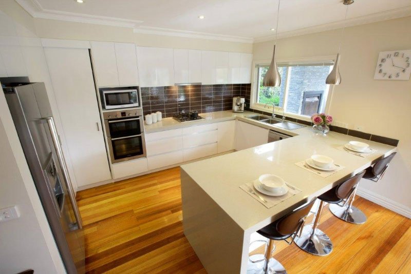 kitchen bar with waterfall counter tops