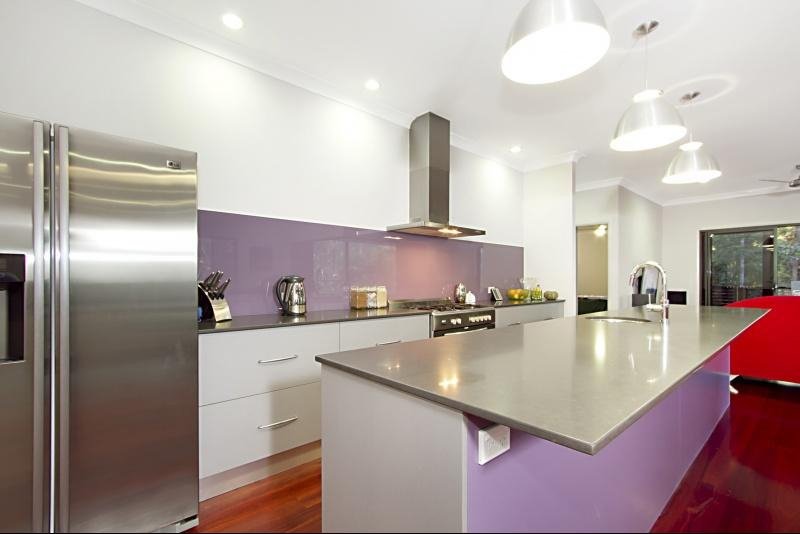 white kitchen island with white counter top and purple accents