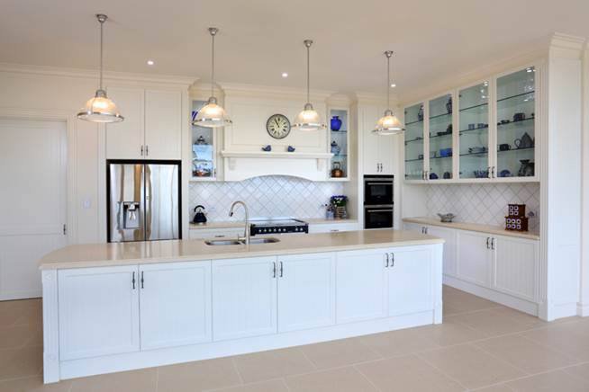 white kitchen island with white counter top