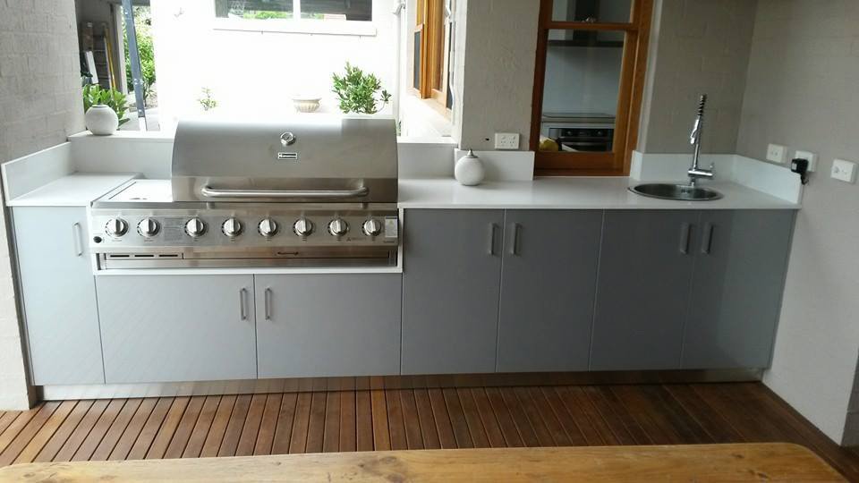 kitchen counter with white benchtop and inset grill