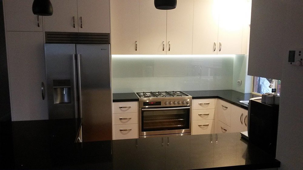 white kitchen counters with black benchtop