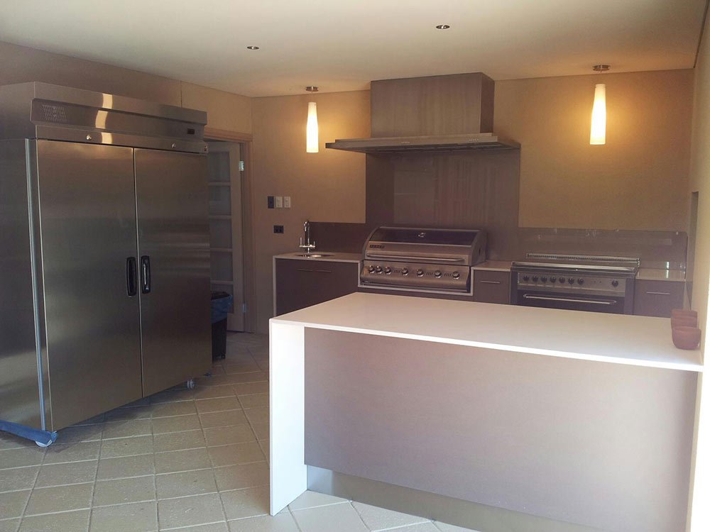kitchen counter with white waterfall benchtop