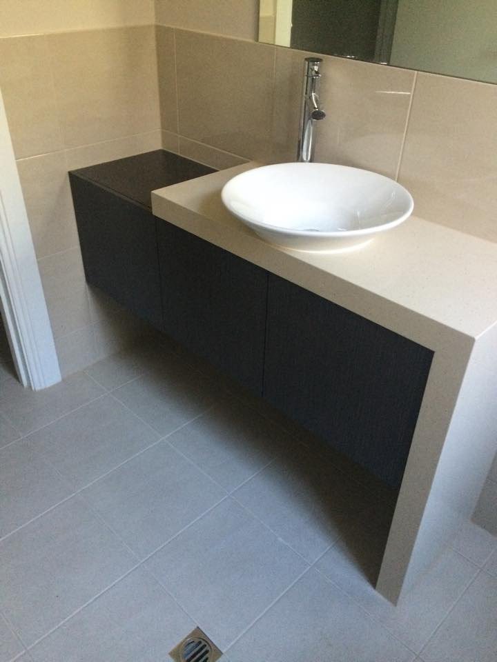 black bathroom counter with white waterfall benchtop