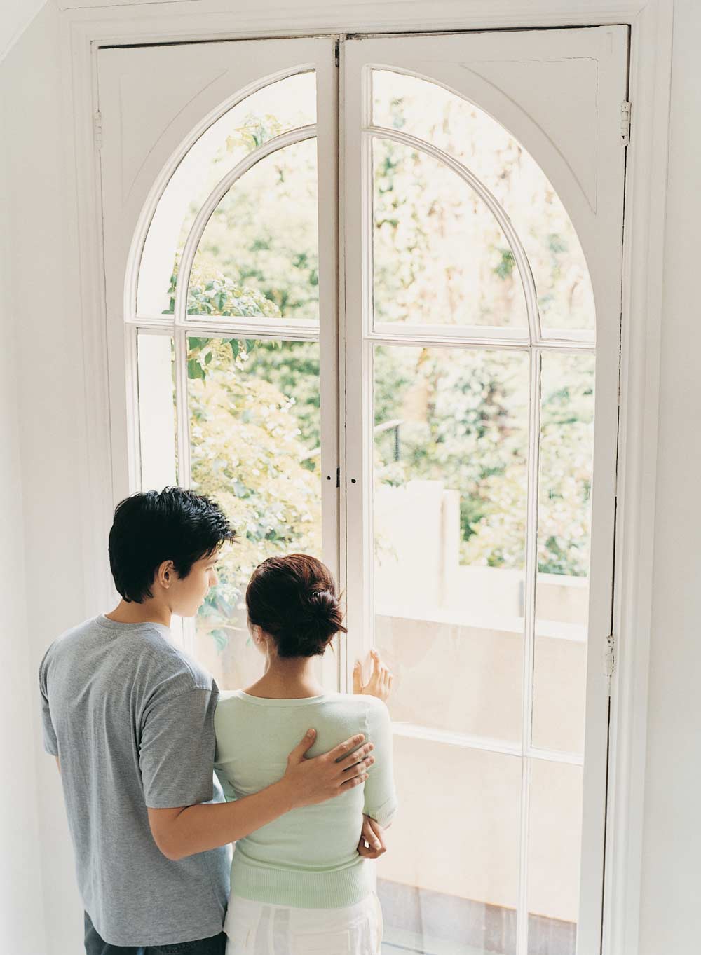 young couple looking out the window