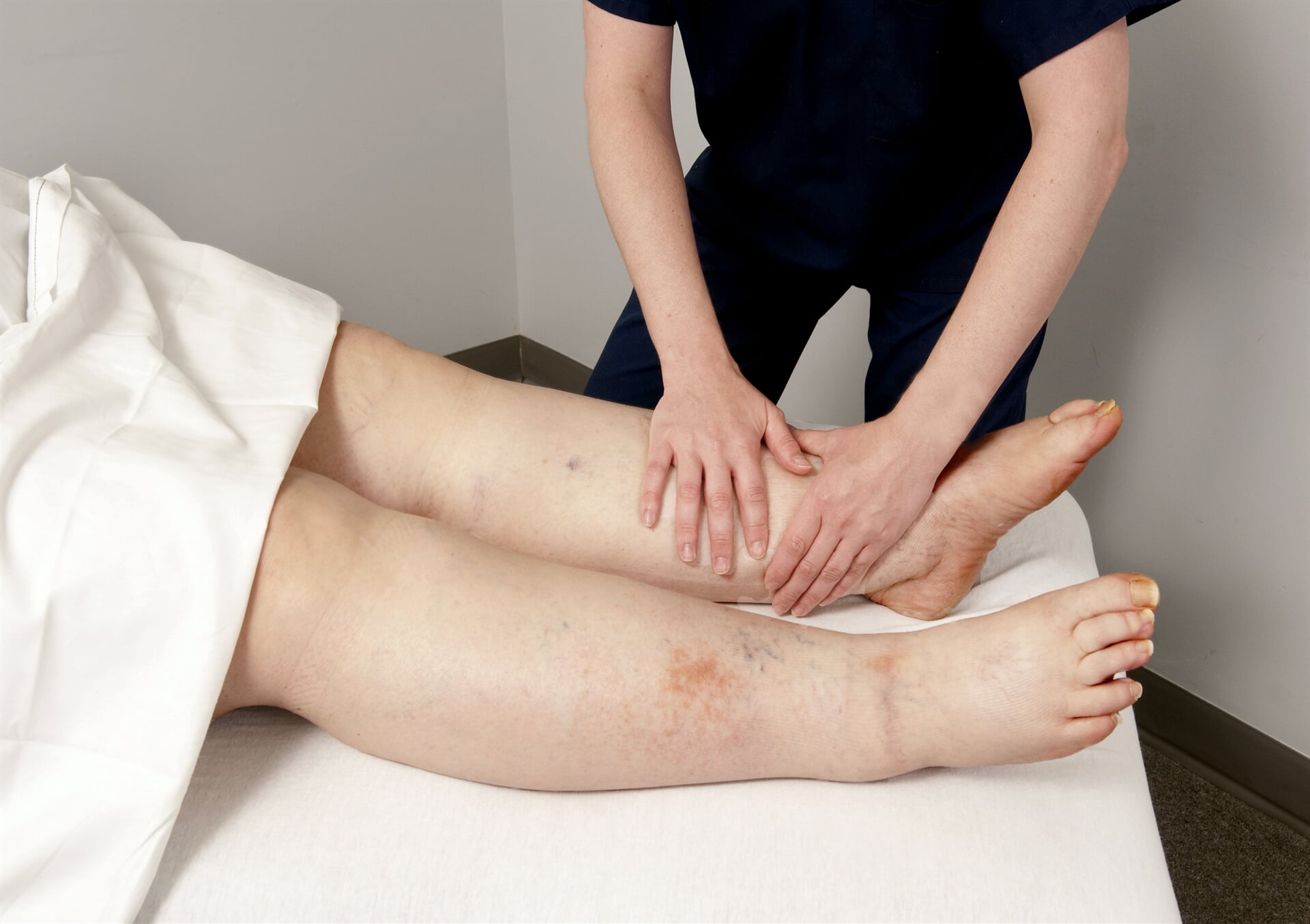 Doctor Bandaging Foot — Goulburn Physiotherapy Centre in Goulburn, NSW