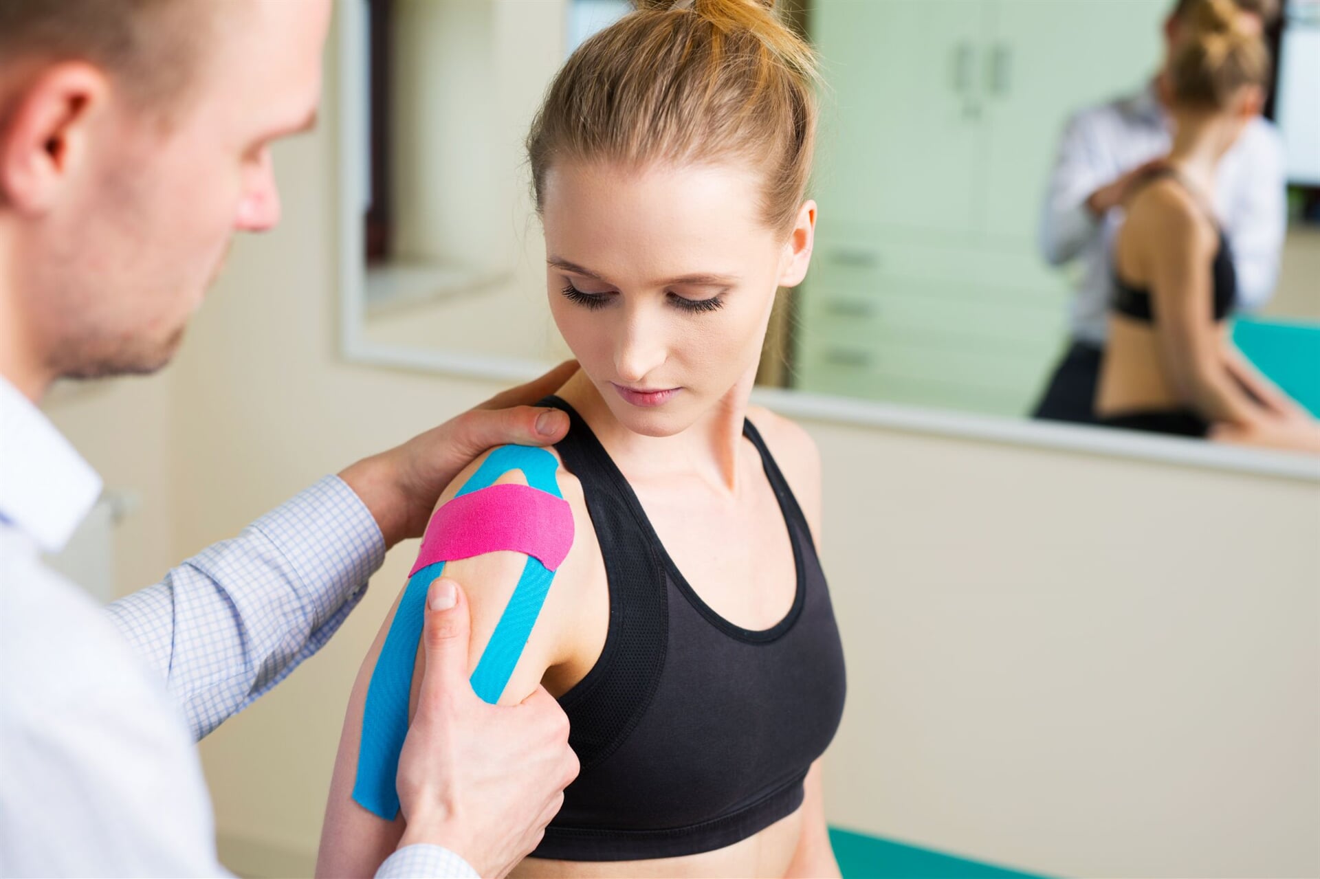 Therapist Applying Kinesiology Tape — Goulburn Physiotherapy Centre in Goulburn, NSW