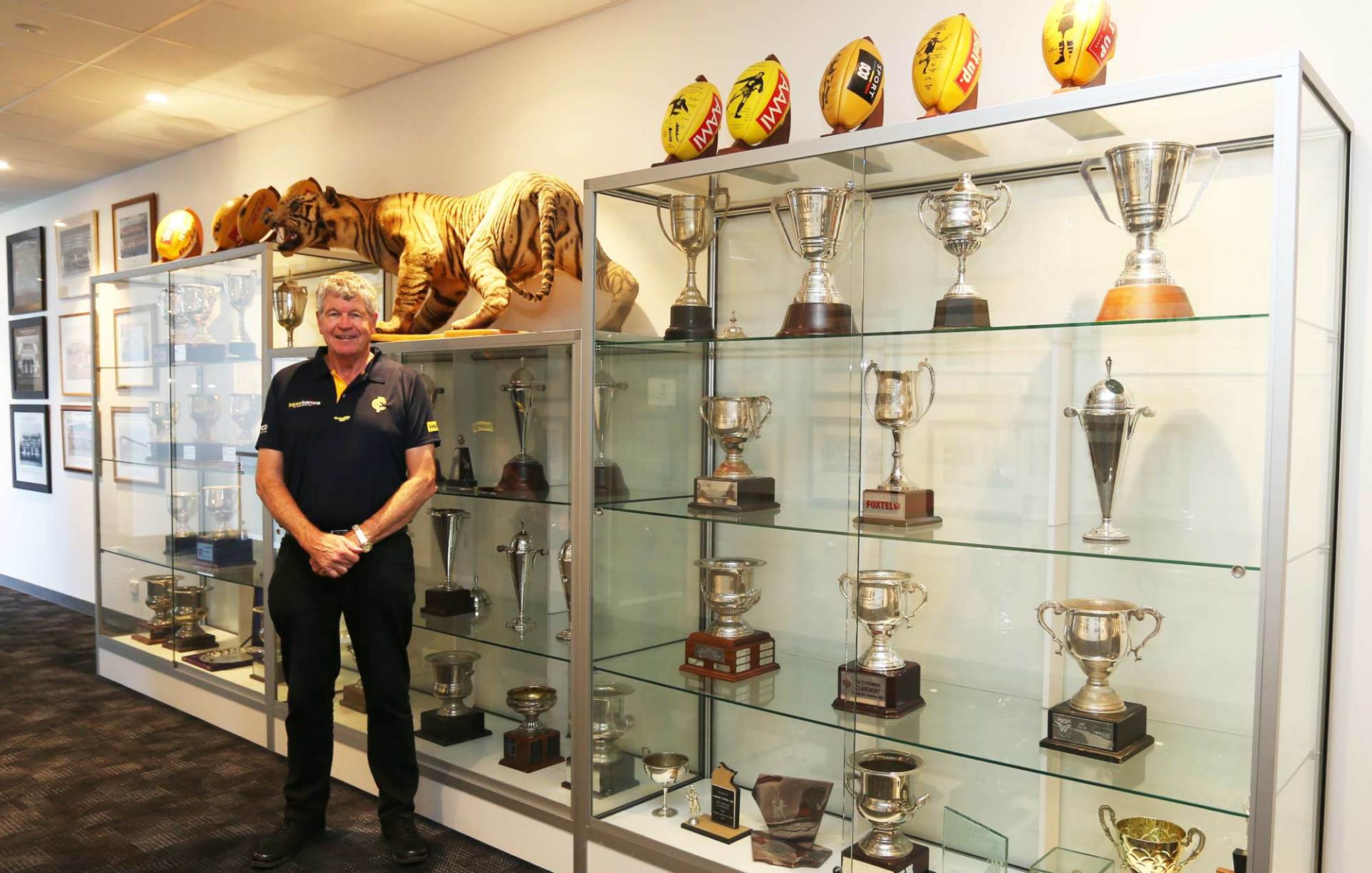 man next to trophy case