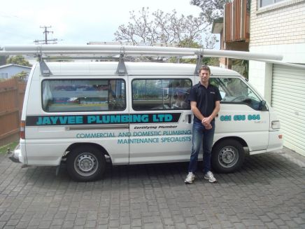 One of our plumbers in front of a van in Auckland