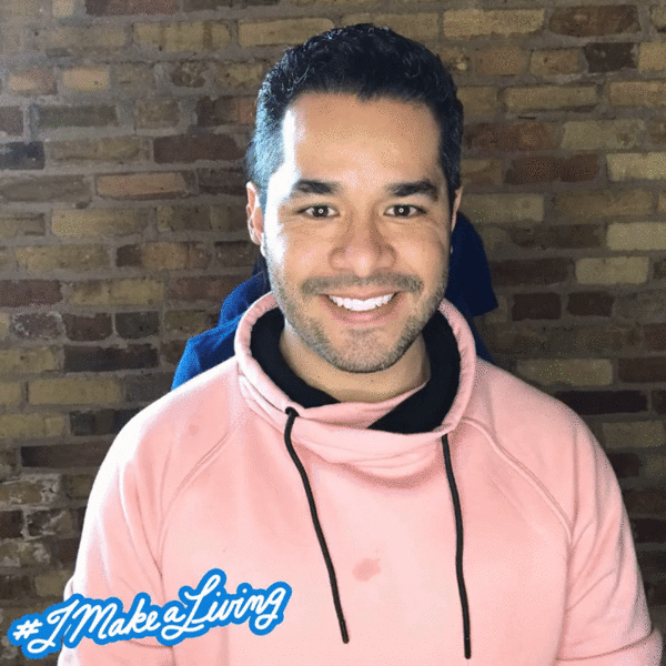 A man wearing a pink sweatshirt with the words 