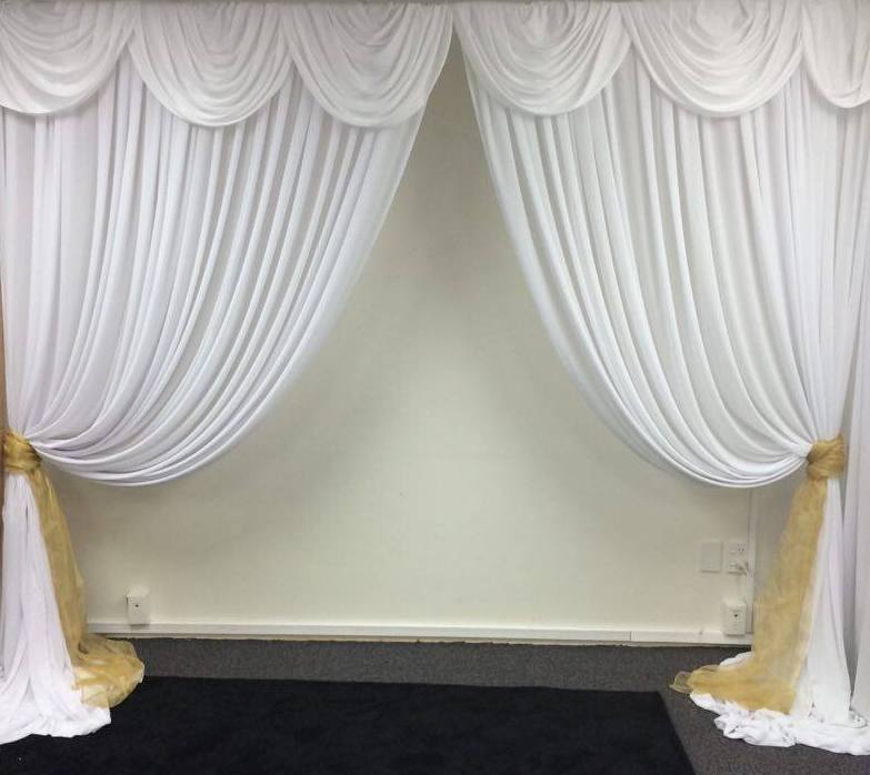 White chiffon entrance way with venetian scallop and gold tie backs
