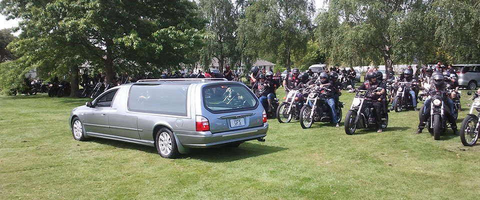 People on bikes  are going for funeral 