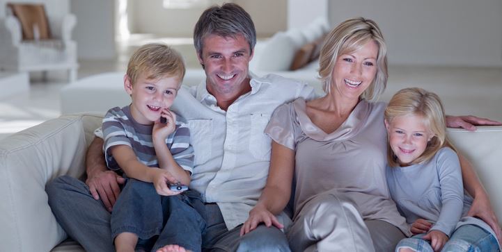 Family watching digitized old family movies together