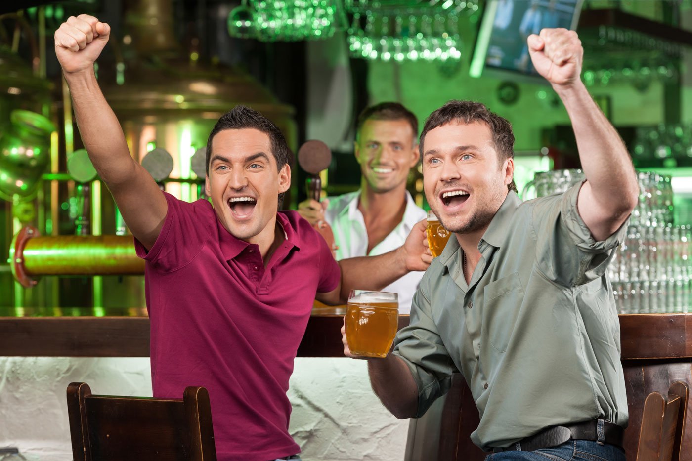 Group of friends celebrating with beer mug in hand