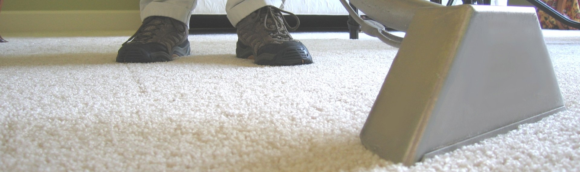 dunlops industrial and commercial cleaning man cleaning carpet with a commercial or industrial vacuum cleaner