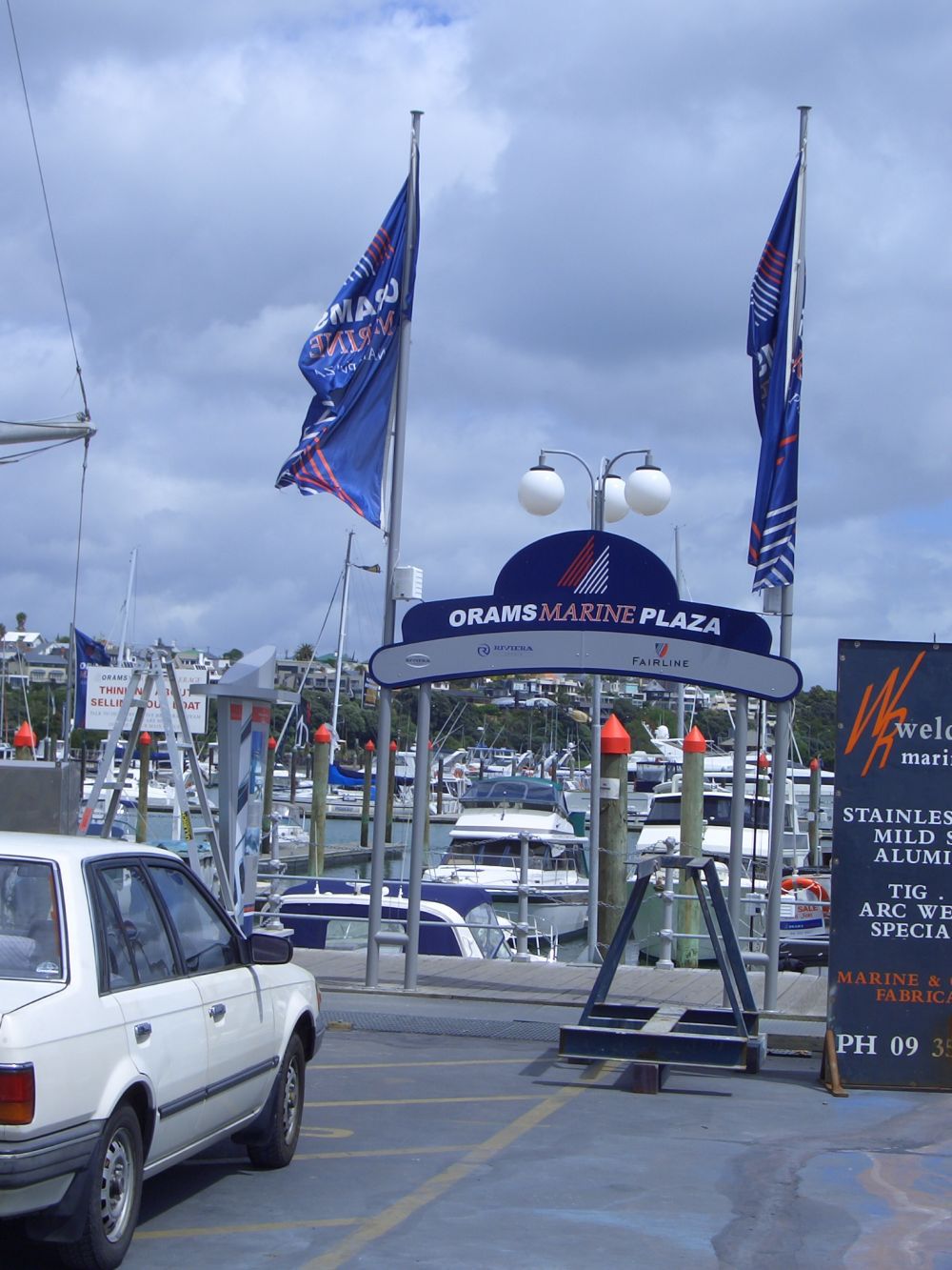 Flagpoles & sign structure on marina timber boardwalk