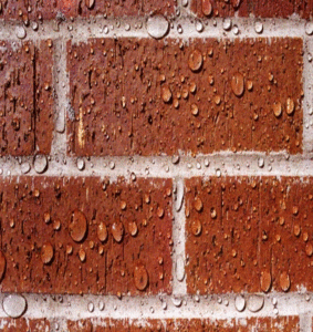 A brick wall with water drops on it