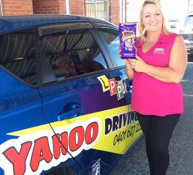 yahoo driving school woman with box standing near the car