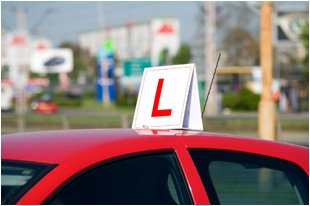  Red car with learner sign on top