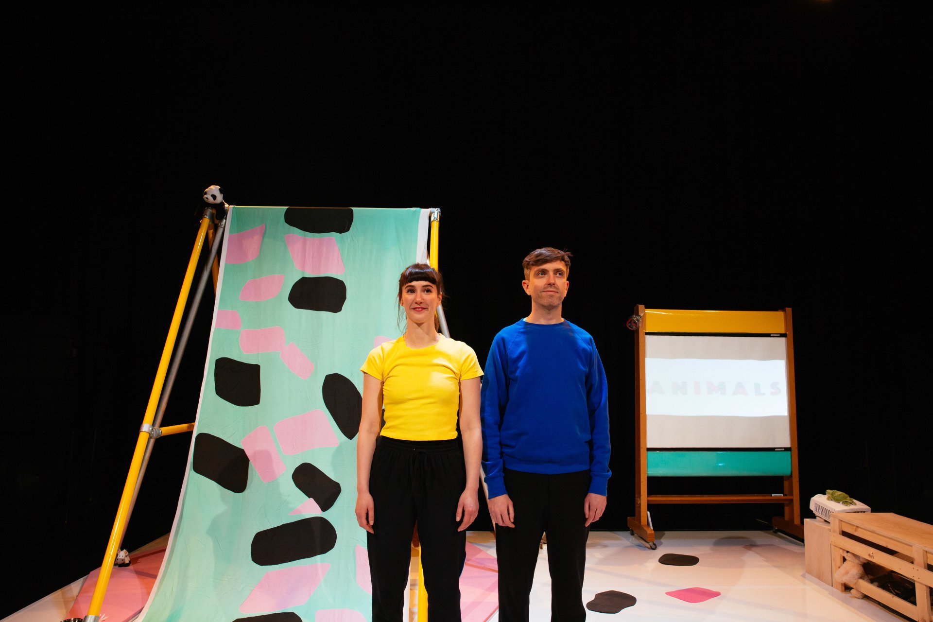 a man and a woman are standing next to each other on a stage .