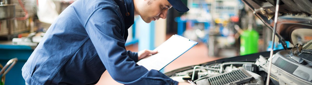 Mechanic looking at car