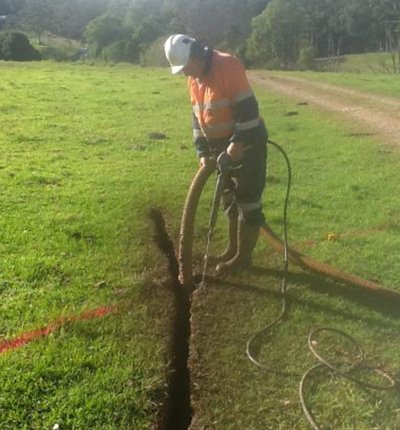 cable and pipe search man digging for pipeline