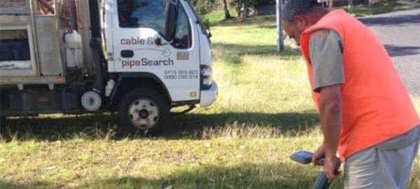 cable and pipe search man standing near truck
