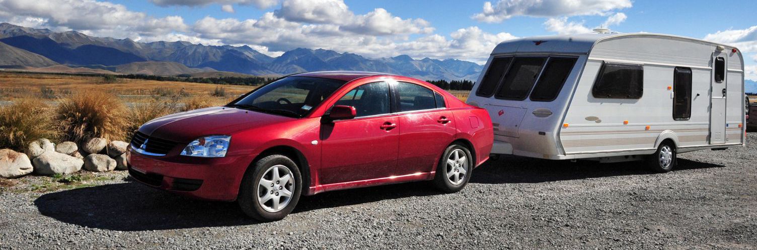 Car pulling trailer thanks to one of our tow bars in Lower Hutt