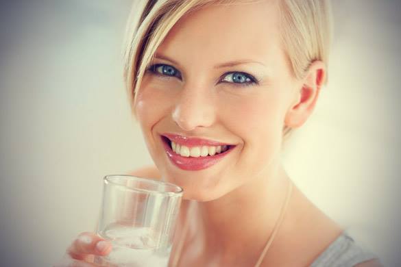 View of of a women drinking fresh water 