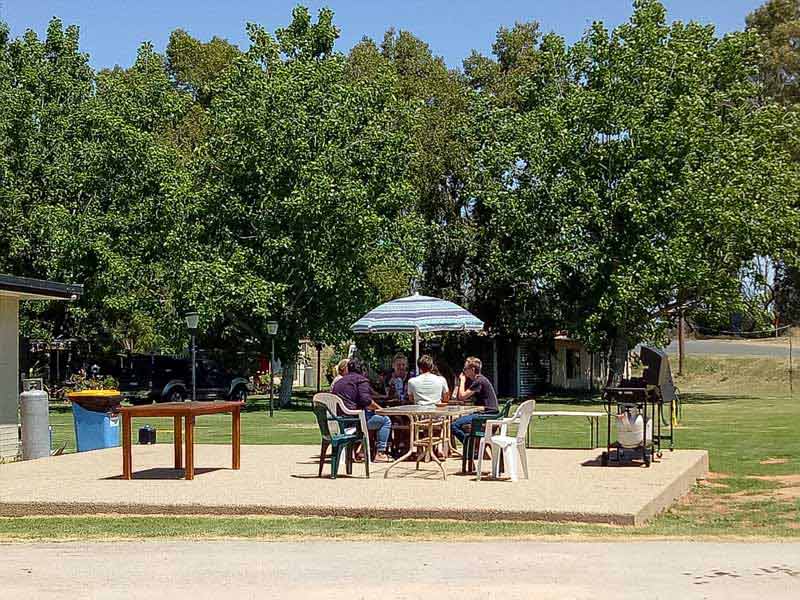 people at table outside in carlwaa