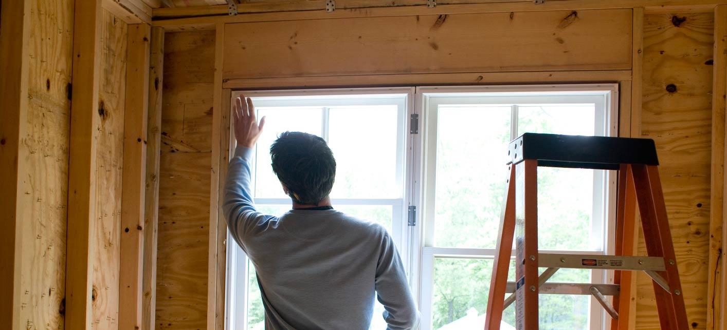 man installing window