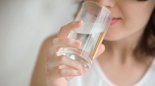 woman drinking water, how do I treat dry mouth blog