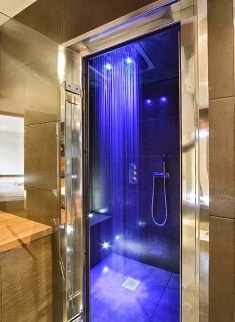 Gold bathroom with blue LED shower lights