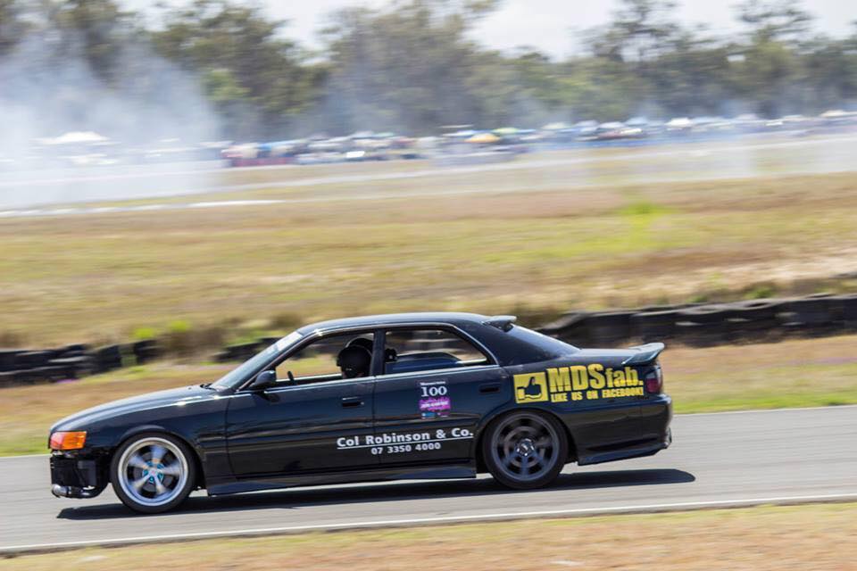 a black car driving on the road or a track
