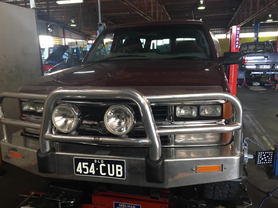 a maroon car and the head lights