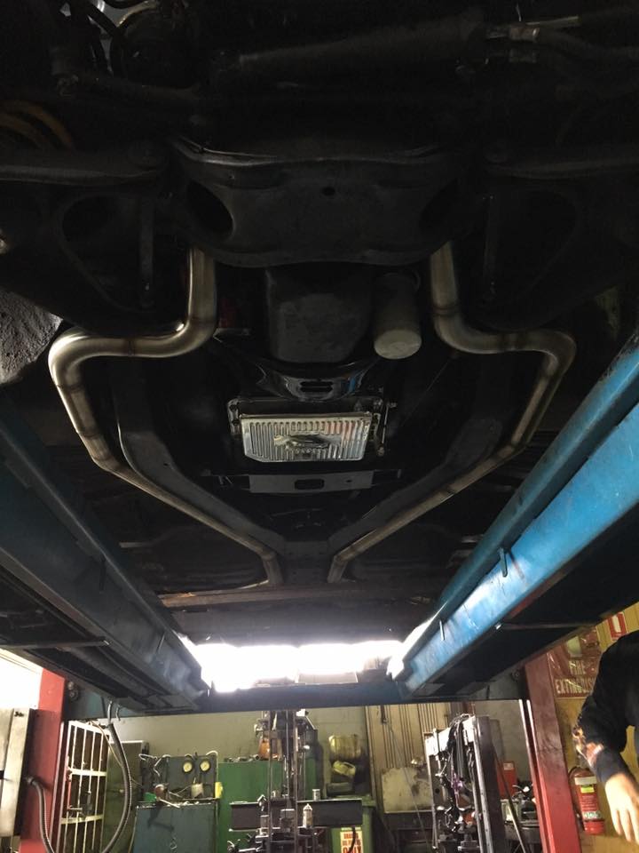 pipes running under a car