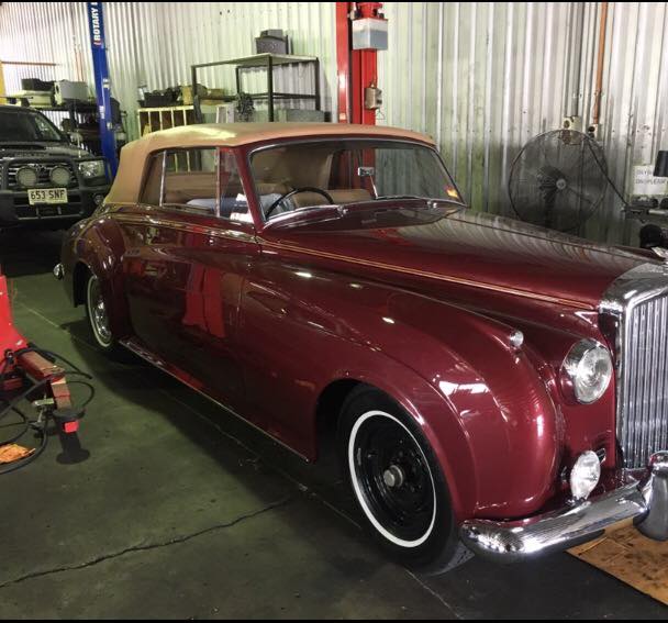 and old red car with a tan roof