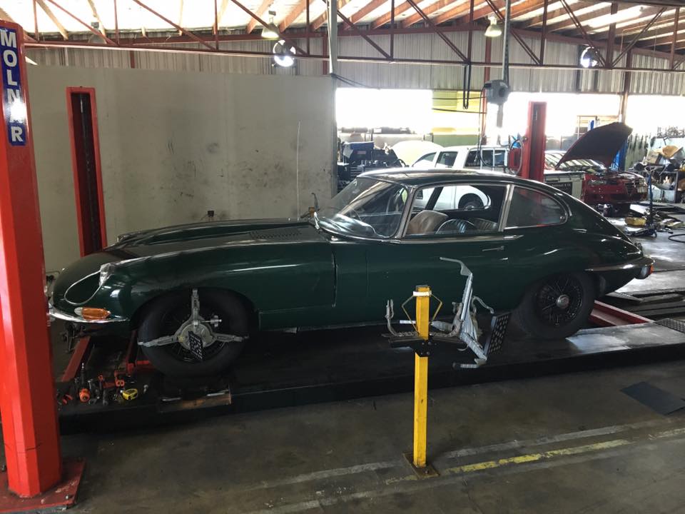 the side of a small green car with a white roof