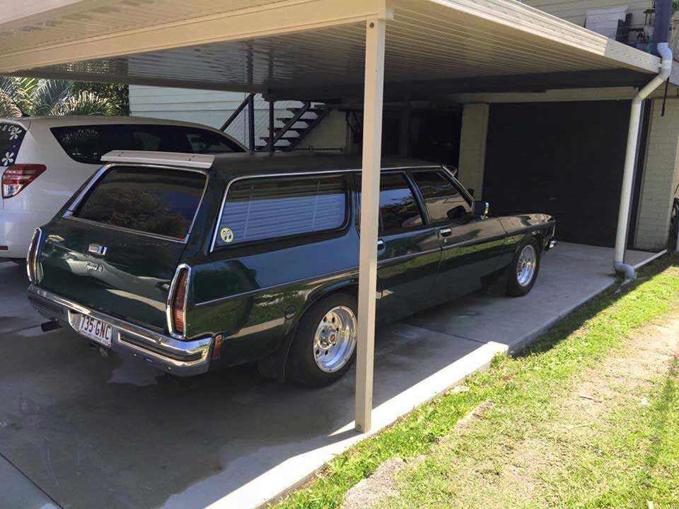 a parked green car in the shade